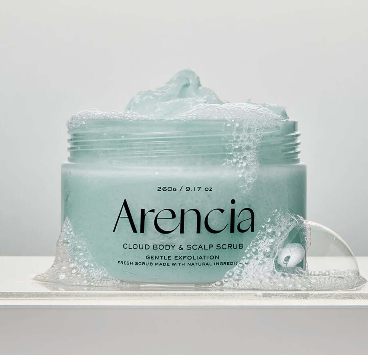 Arencia Fresh Cloud Body & Scalp Scrub-Lavender & Pear in a jar with bubbles, offering gentle exfoliation.