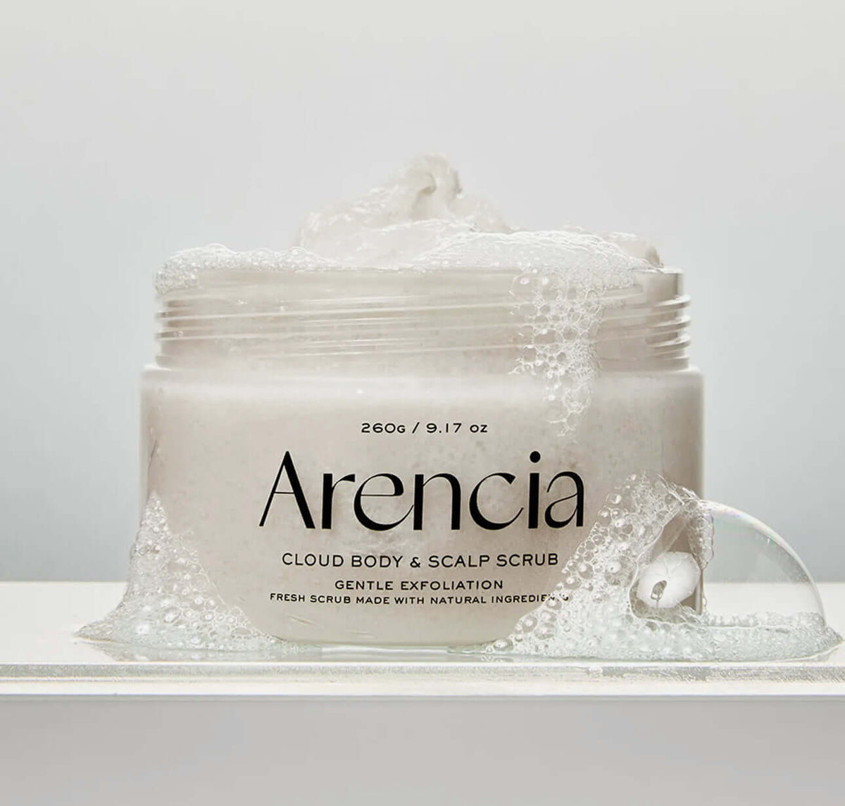 Arencia Fresh Cloud Body & Scalp Scrub-Lavender & Pear in a jar with gentle exfoliation bubbles.